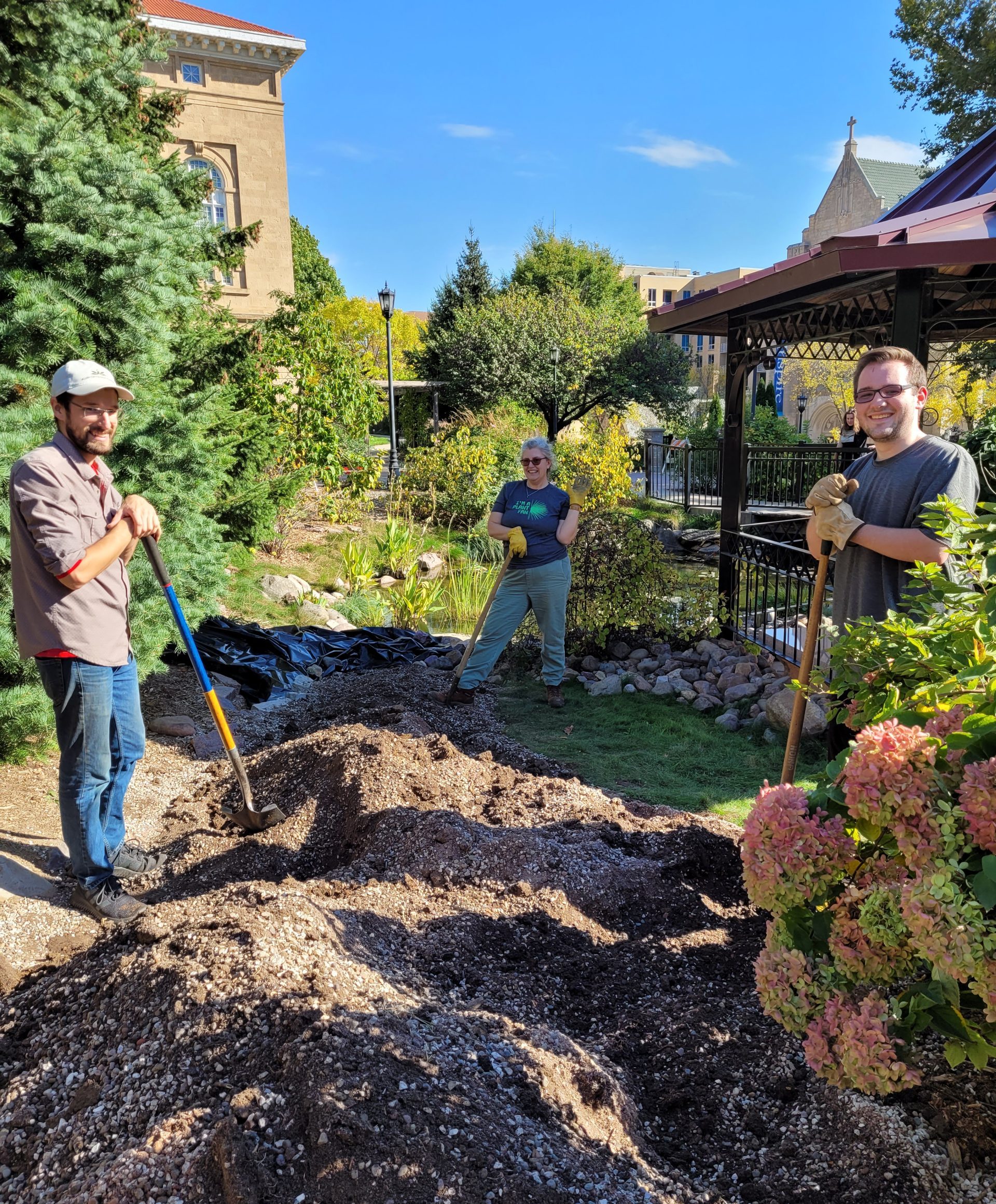 smiling workers with shovels